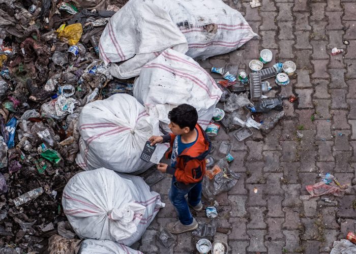 Canva - Child Standing Near Garbage