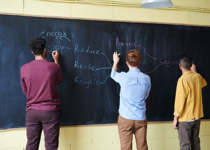 Canva - Men wriiting on Blackboard with Chalks