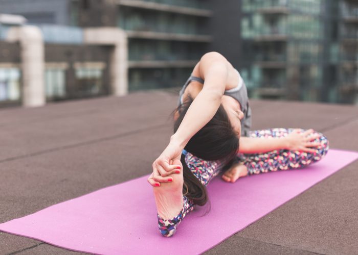 Canva - Woman Doing Yoga Pose on Pink Yoga Mat
